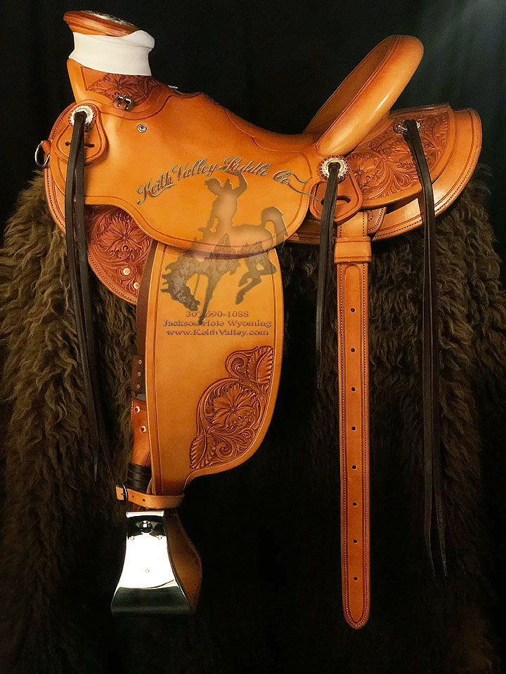 16 inch seat 94 degree bars Wade Saddle. 1/2 Sheridan style floral tooled, 7/8ths Stainless Steel rigging, cantle 5 inch high by 12 & 1/2 inch wide. Saddle hand built by Keith Valley.